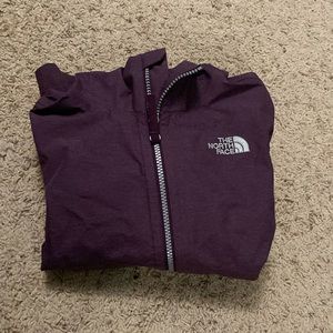 The North Face purple rain jacket with a hood and pockets for girls size small
